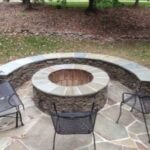 Round Stacked Stone Fire Pit and Stone Seating